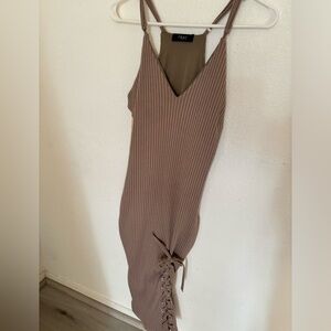 Trac dress with beautiful lacing on the leg.